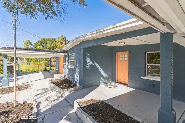 a view of a patio with couches chairs and potted plants