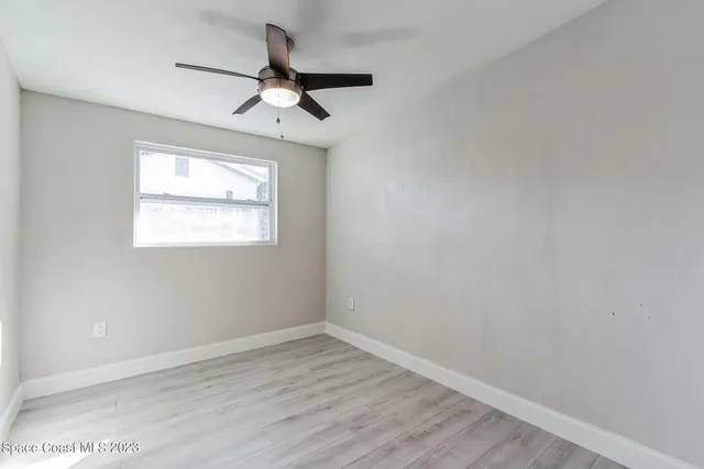 wooden floor in an empty room with a window