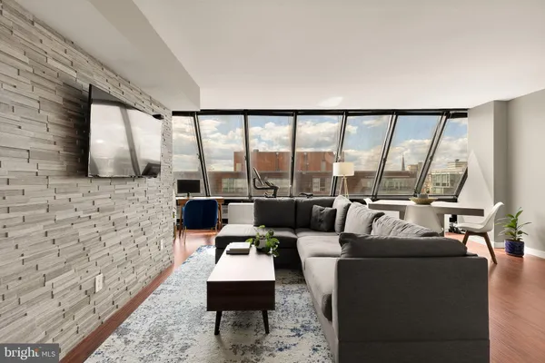 a living room with fireplace furniture and a floor to ceiling window