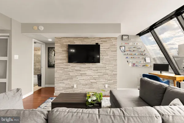 a living room with furniture and a flat screen tv