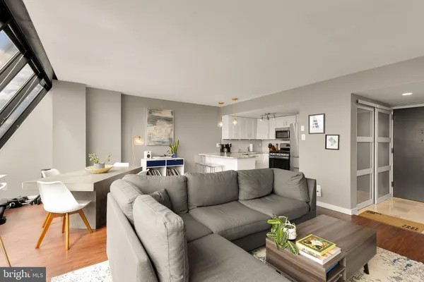 a living room with furniture and a wooden floor