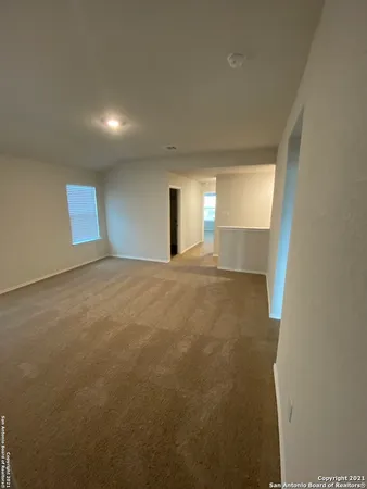 a view of a big room with windows and fireplace