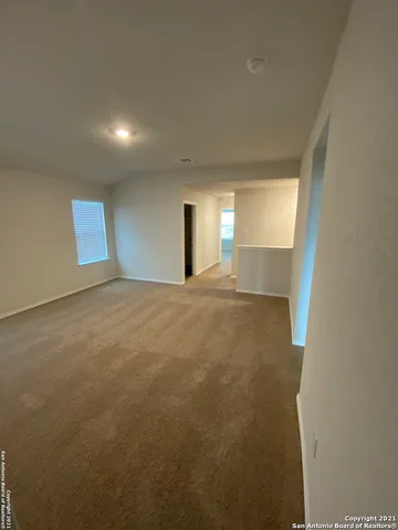 a view of a big room with windows and fireplace