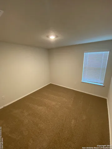 an empty room with a empty space and windows