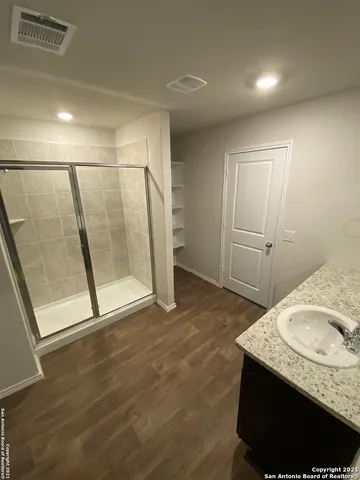a bathroom with a granite countertop sink and a mirror
