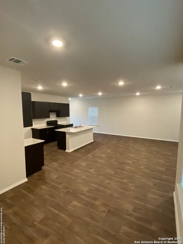 a view of kitchen with kitchen island sink stainless steel appliances and cabinets