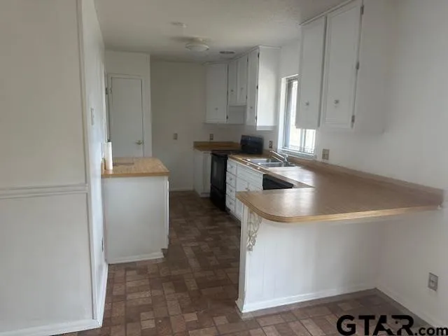 a kitchen that has a sink and a stove