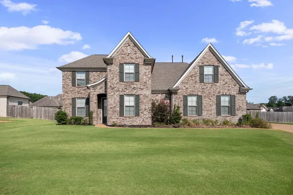 a front view of a house with a yard