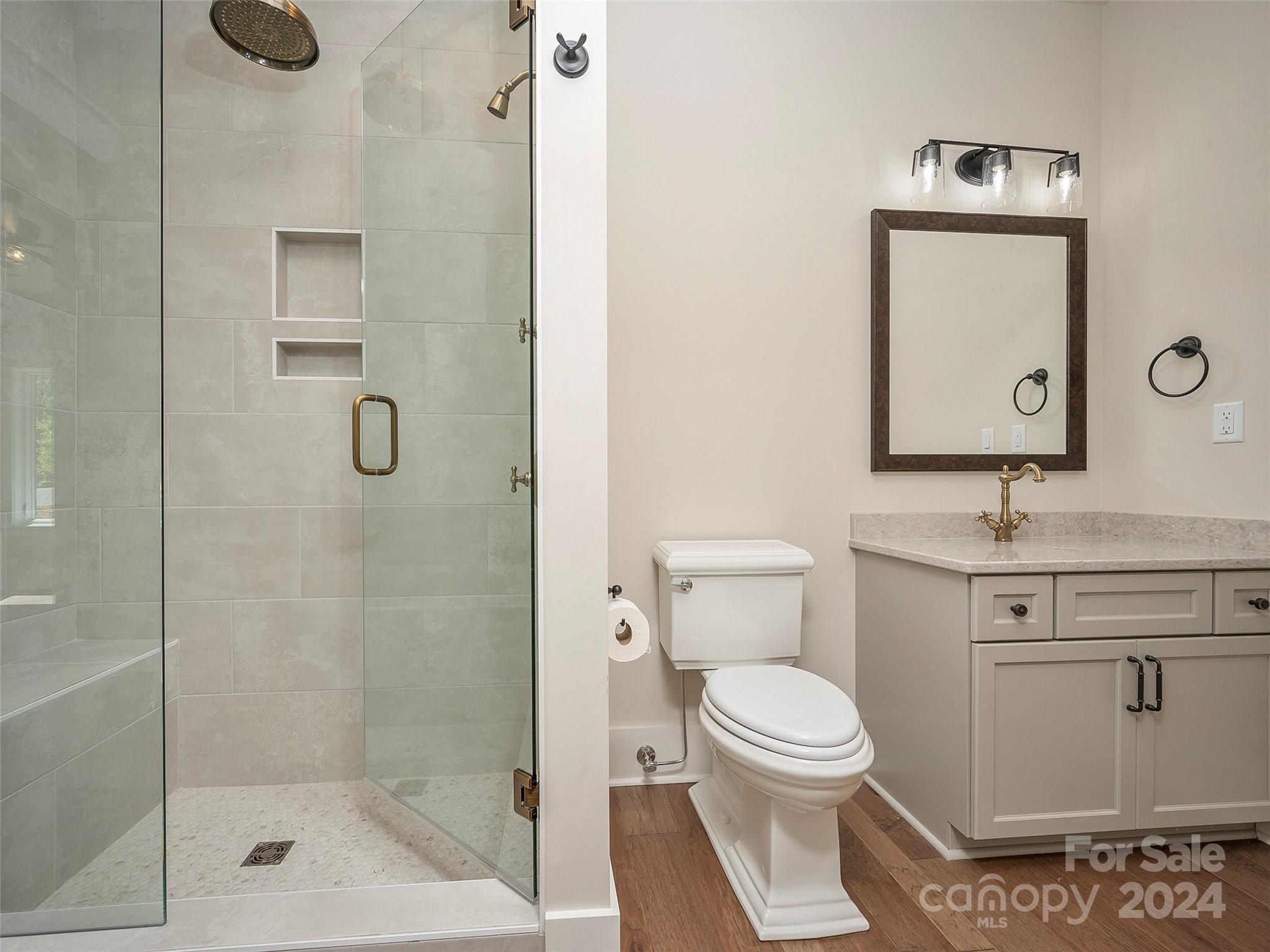 87 Jackson Ridge Ln Mill Spring, Unit 4 Mill Spring, NC 28756 - Photo 13 of 48 a bathroom with a toilet sink and shower