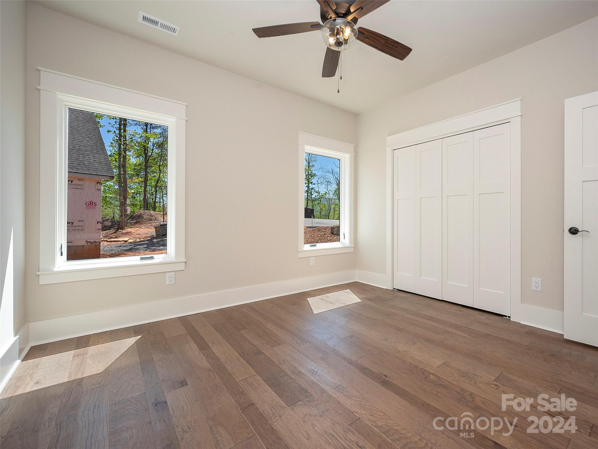87 Jackson Ridge Ln Mill Spring, Unit 4 Mill Spring, NC 28756 - Photo 15 of 48 wooden floor in an empty room with a window