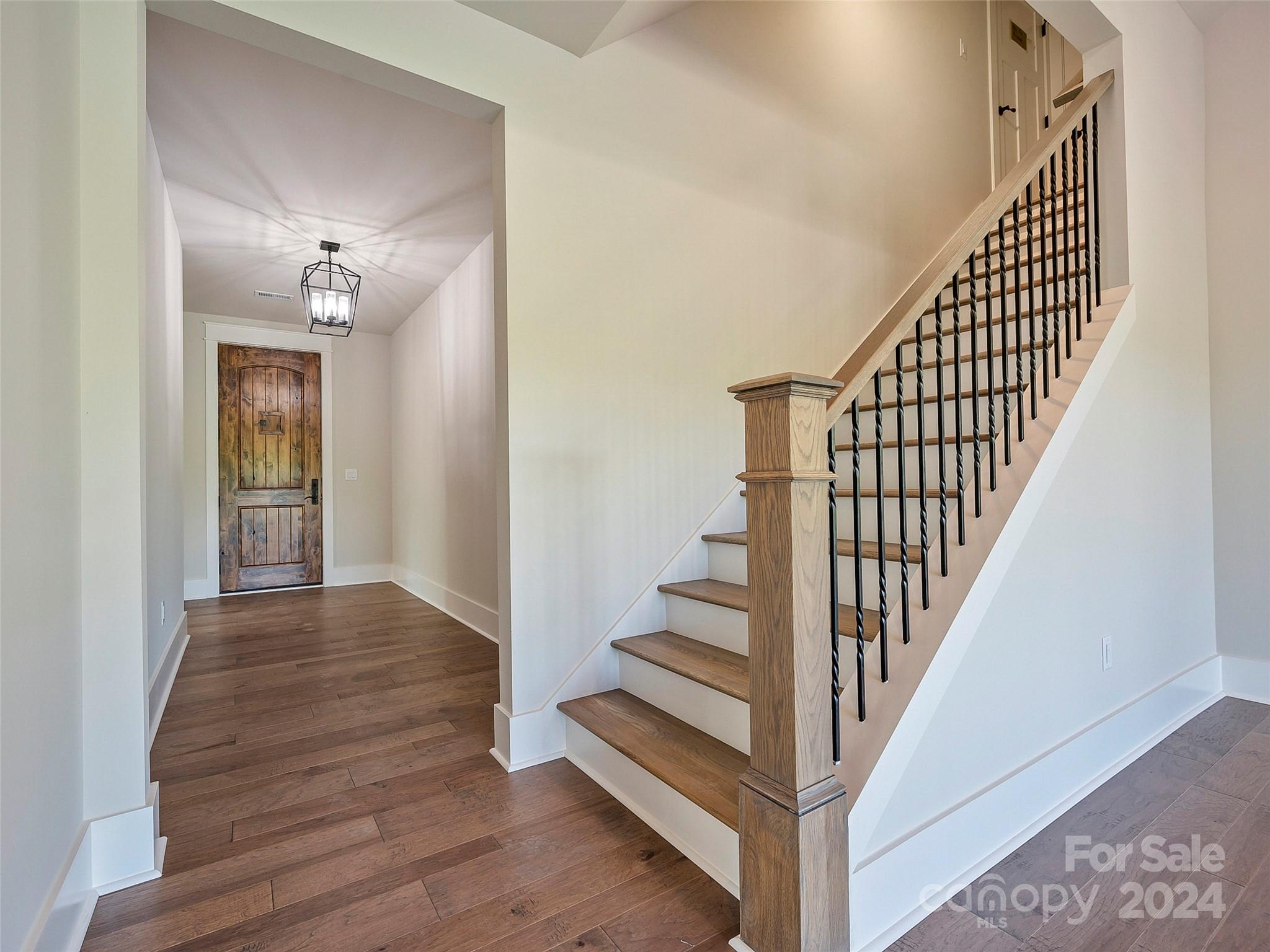 87 Jackson Ridge Ln Mill Spring, Unit 4 Mill Spring, NC 28756 - Photo 17 of 48 a view of a hallway with wooden floor and staircase