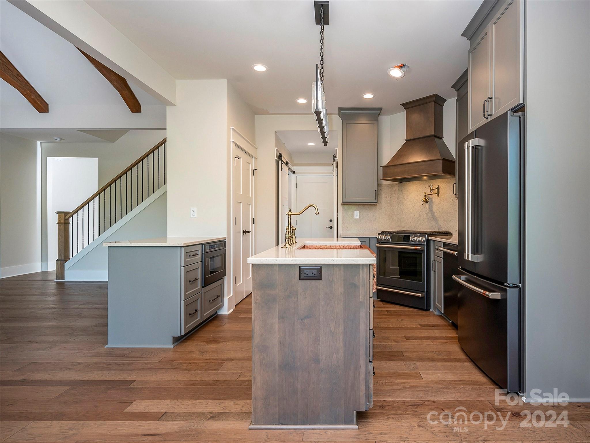 87 Jackson Ridge Ln Mill Spring, Unit 4 Mill Spring, NC 28756 - Photo 21 of 48 a kitchen with stainless steel appliances kitchen island a refrigerator sink and stove