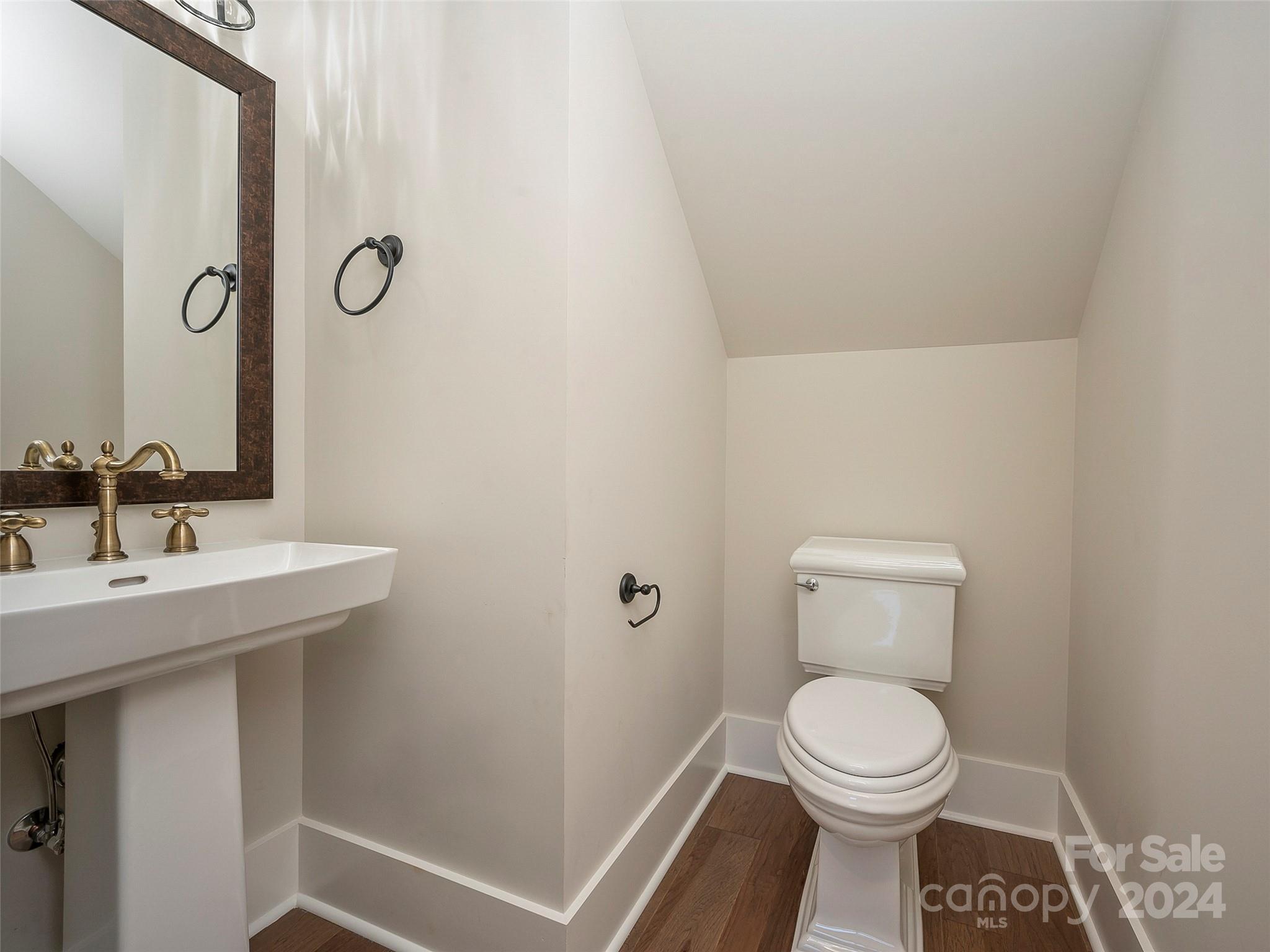 87 Jackson Ridge Ln Mill Spring, Unit 4 Mill Spring, NC 28756 - Photo 27 of 48 a bathroom with a toilet a sink and mirror