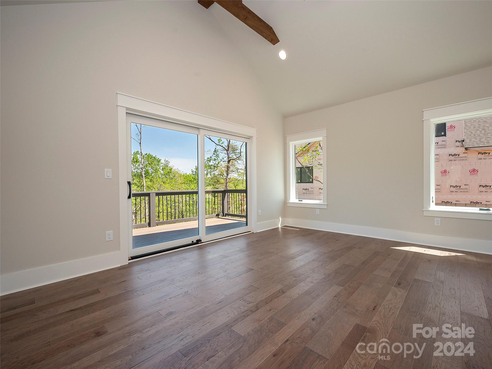 87 Jackson Ridge Ln Mill Spring, Unit 4 Mill Spring, NC 28756 - Photo 28 of 48 a view of an empty room with wooden floor and a window