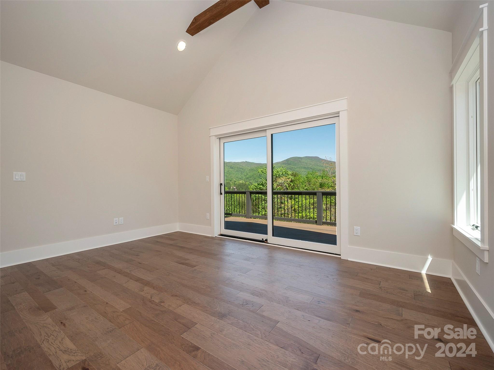 87 Jackson Ridge Ln Mill Spring, Unit 4 Mill Spring, NC 28756 - Photo 29 of 48 an empty room with wooden floor and windows