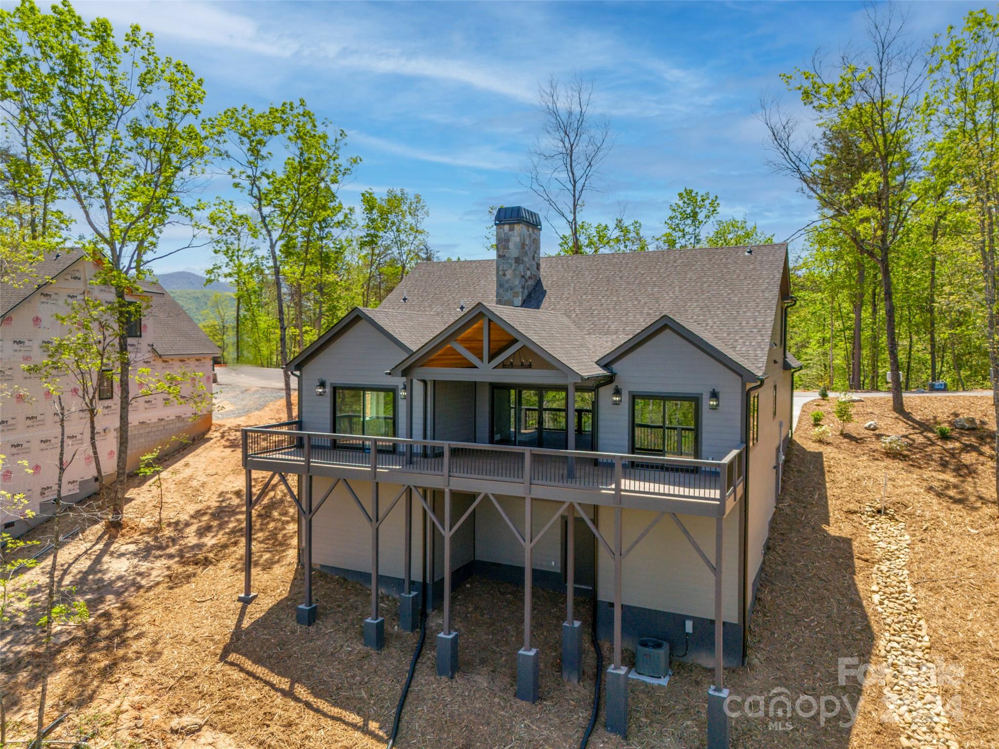 87 Jackson Ridge Ln Mill Spring, Unit 4 Mill Spring, NC 28756 - Photo 40 of 48 an aerial view of a house with table and chairs
