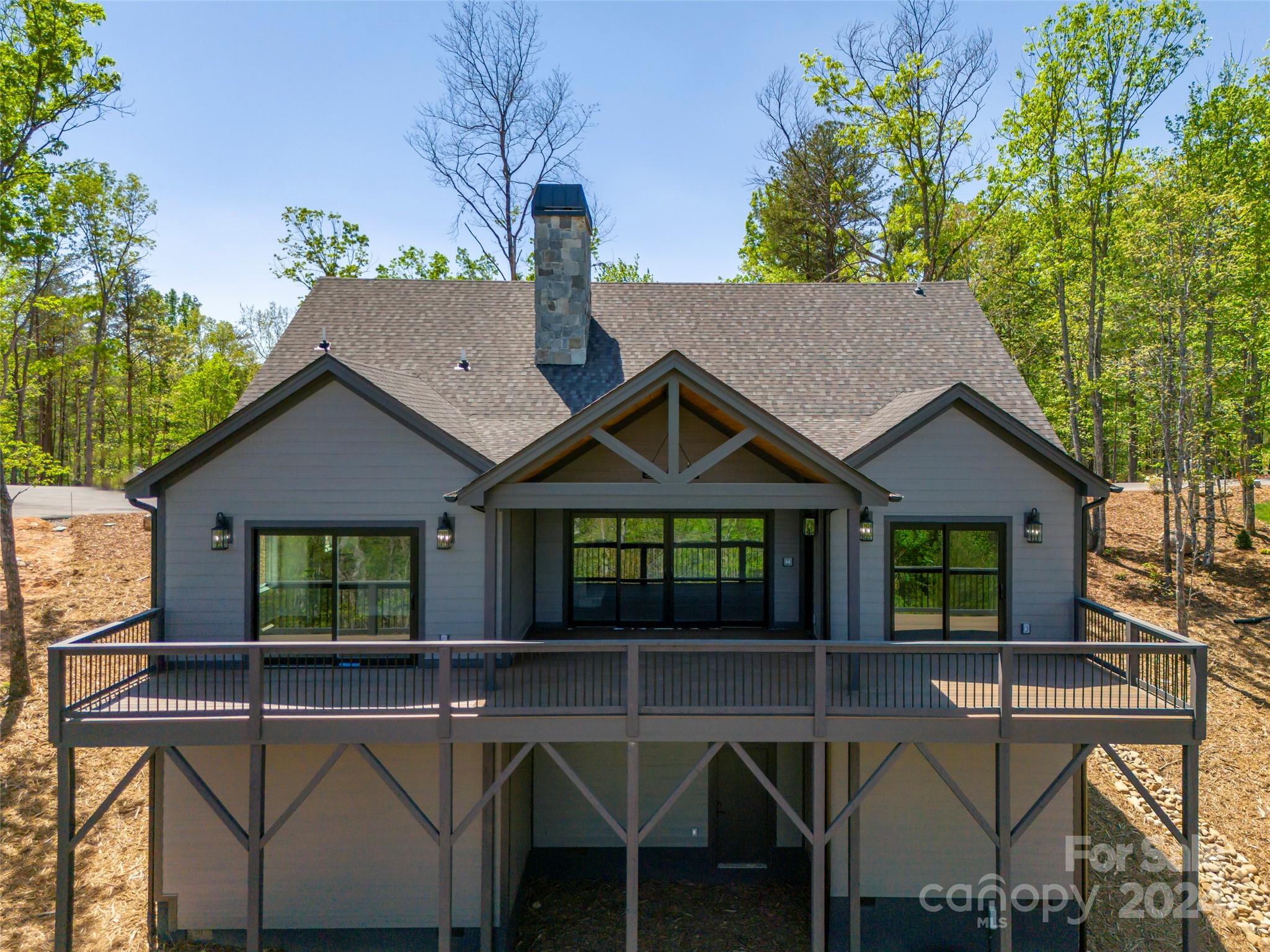 87 Jackson Ridge Ln Mill Spring, Unit 4 Mill Spring, NC 28756 - Photo 41 of 48 a view of a house with a chairs in patio