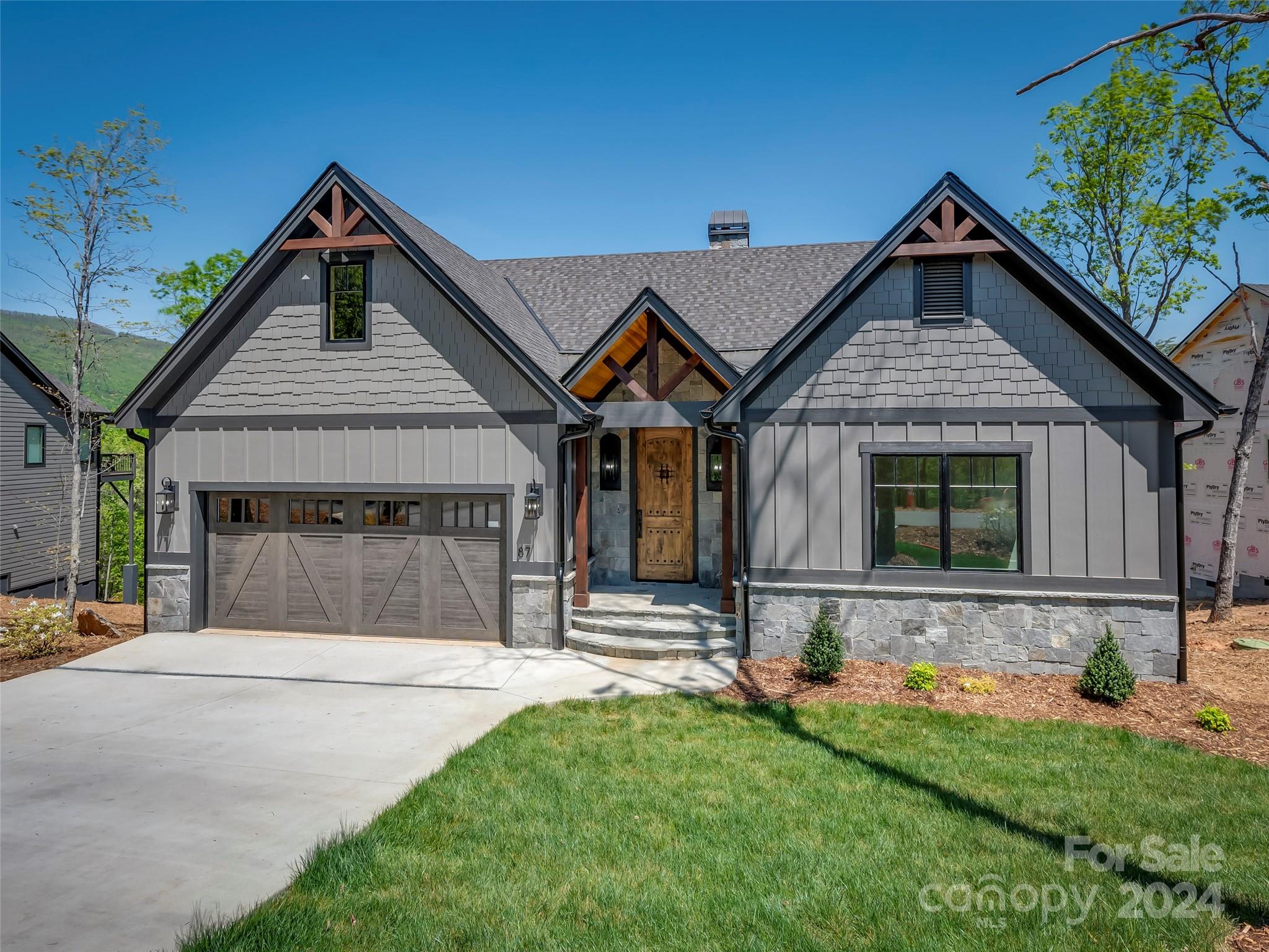 87 Jackson Ridge Ln Mill Spring, Unit 4 Mill Spring, NC 28756 - Photo 5 of 48 a front view of a house with a yard