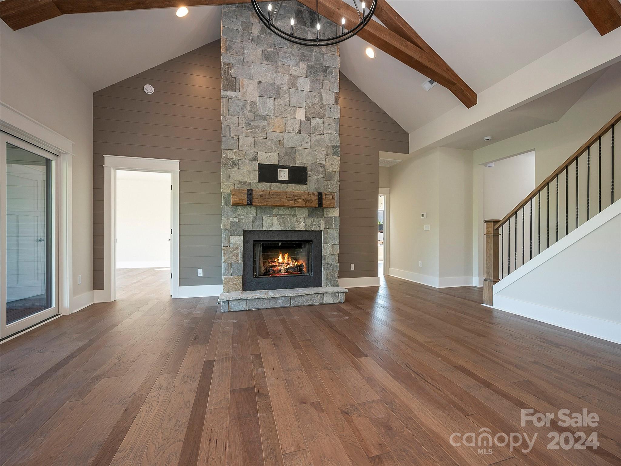87 Jackson Ridge Ln Mill Spring, Unit 4 Mill Spring, NC 28756 - Photo 6 of 48 a view of an empty room with wooden floor and a fire place