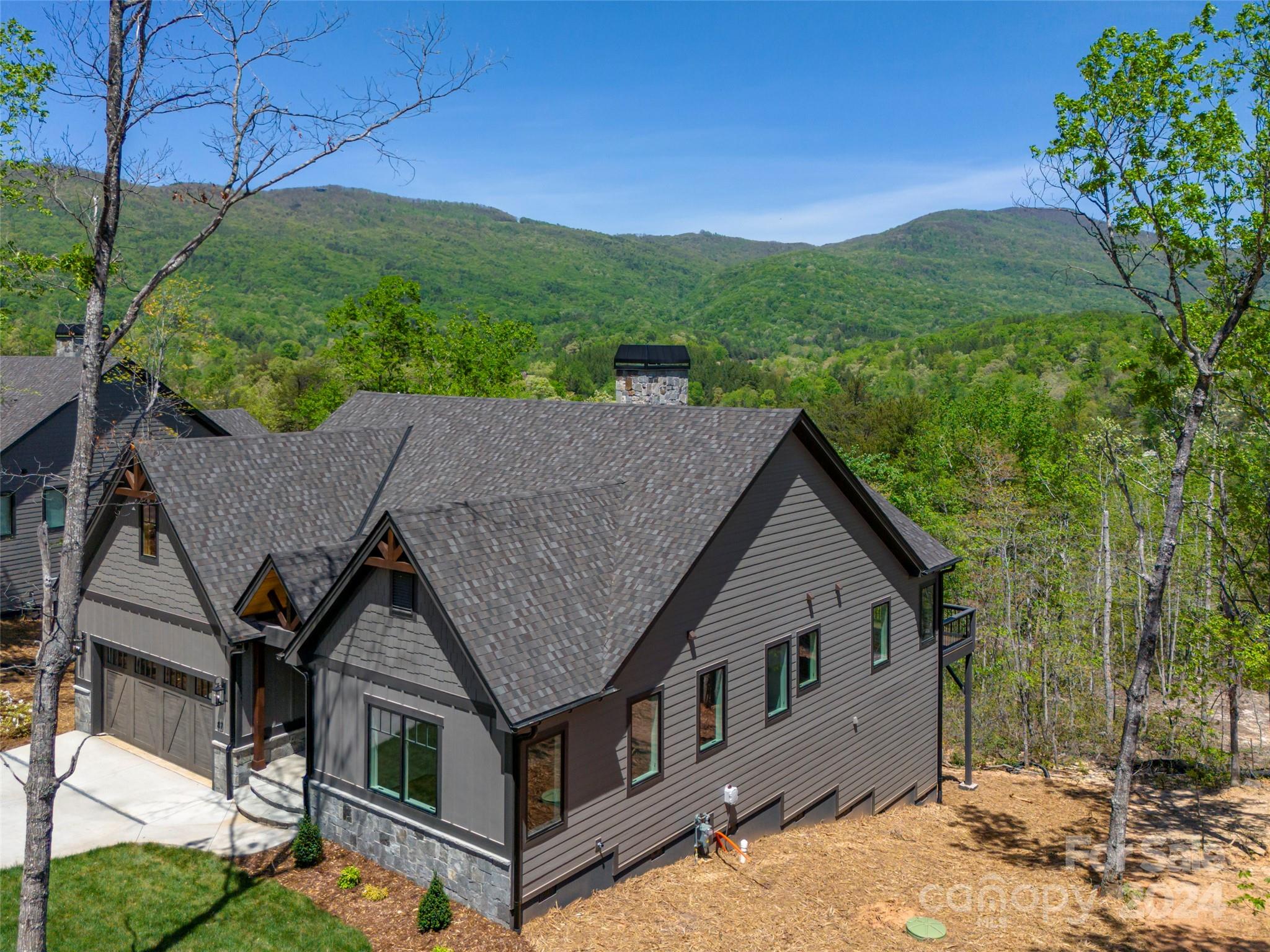 87 Jackson Ridge Ln Mill Spring, Unit 4 Mill Spring, NC 28756 - Photo 8 of 48 a aerial view of a house next to a yard