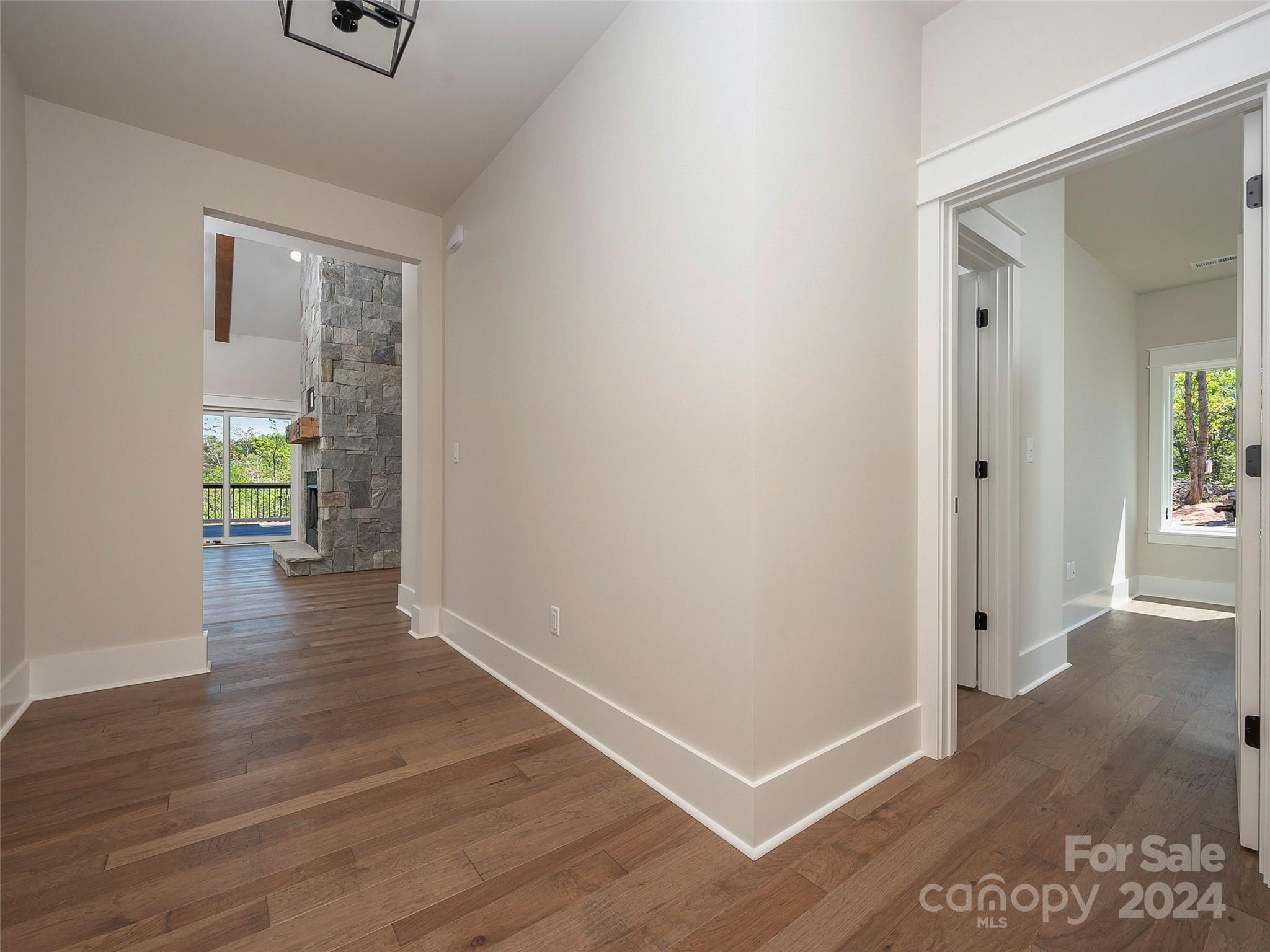 87 Jackson Ridge Ln Mill Spring, Unit 4 Mill Spring, NC 28756 - Photo 10 of 48 an empty room with wooden floor and windows