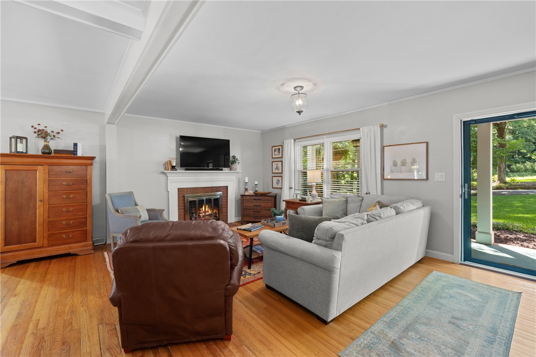 203 Augusta Road Clemson, SC 29631 - Photo 6 of 31 Hardwood floors and a welcoming fireplace anchor this comfortable living space.