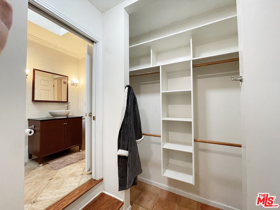 6464 Newcastle Avenue Reseda, CA 91335 - Photo 11 of 17 a view of walk in closet with empty racks