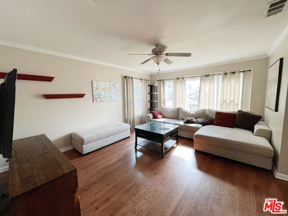 6464 Newcastle Avenue Reseda, CA 91335 - Photo 3 of 17 a living room with furniture and a wooden floor