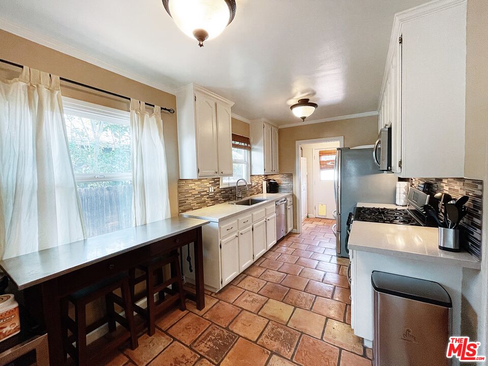 6464 Newcastle Avenue Reseda, CA 91335 - Photo 6 of 17 a large kitchen with kitchen island a sink stainless steel appliances and cabinets