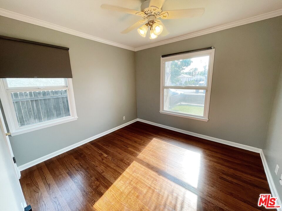 6464 Newcastle Avenue Reseda, CA 91335 - Photo 9 of 17 a view of an empty room with wooden floor and a window