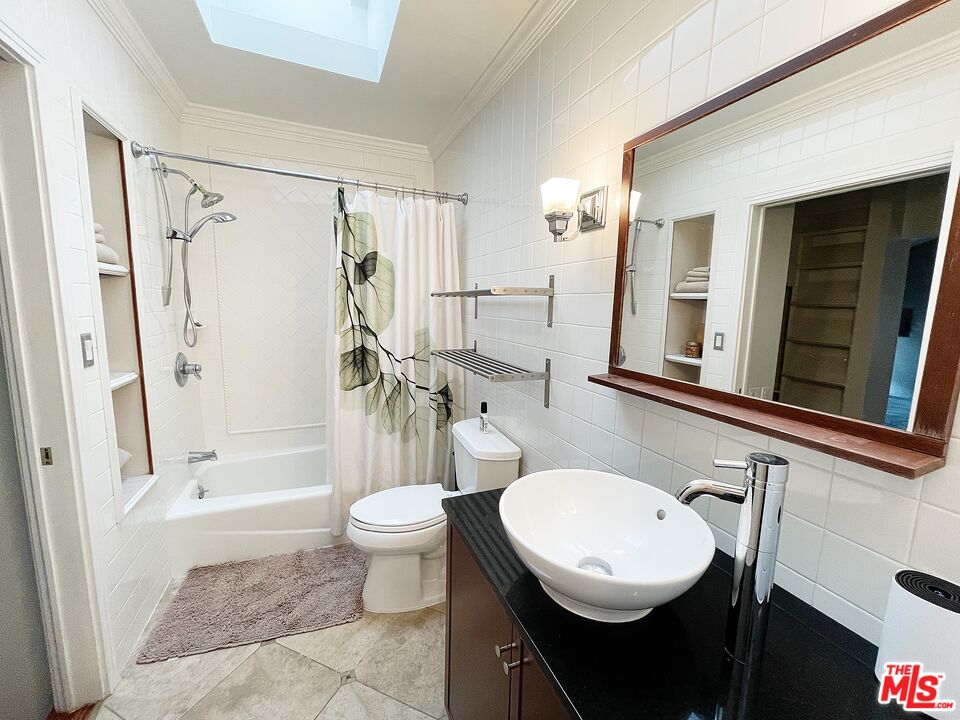 6464 Newcastle Avenue Reseda, CA 91335 - Photo 10 of 17 a bathroom with a sink toilet a mirror and shower