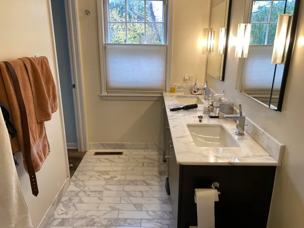 a bathroom with a sink a mirror and a shower