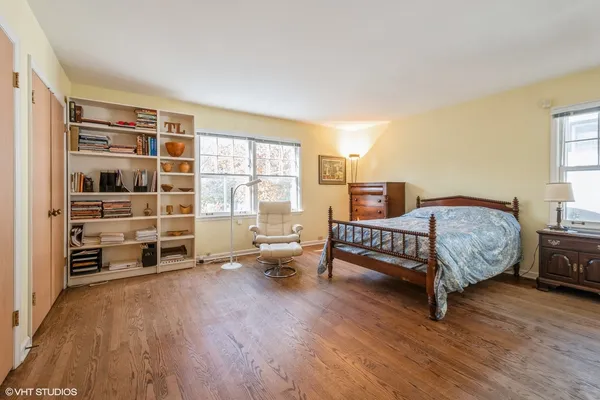 a spacious bedroom with a bed and a large window