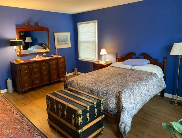 a bedroom with a bed and window