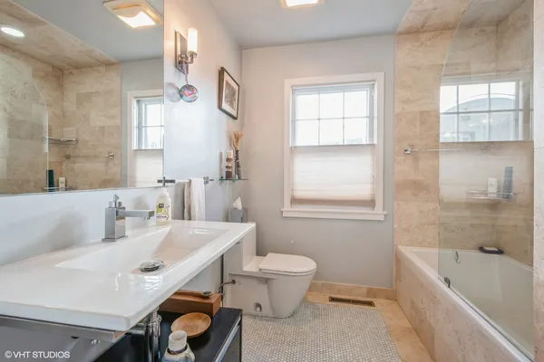 a bathroom with a sink toilet tub and shower
