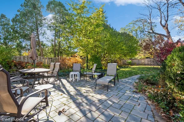 a view of a patio with table and chairs and potted plants
