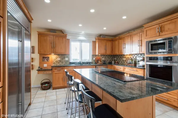 a kitchen with a refrigerator a stove a sink and a microwave