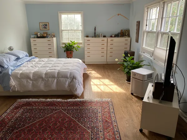 a bedroom with a bed and wooden floor
