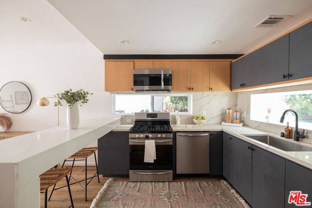 a kitchen with a sink and cabinets