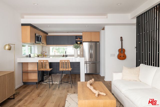 a living room filled with furniture and a potted plant