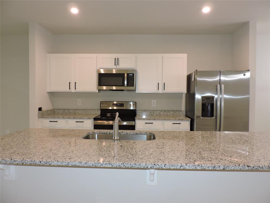 836 Persimmon Place Fort Pierce, FL 34981 - Photo 12 of 78 a kitchen with a sink a counter top space cabinets and stainless steel appliances