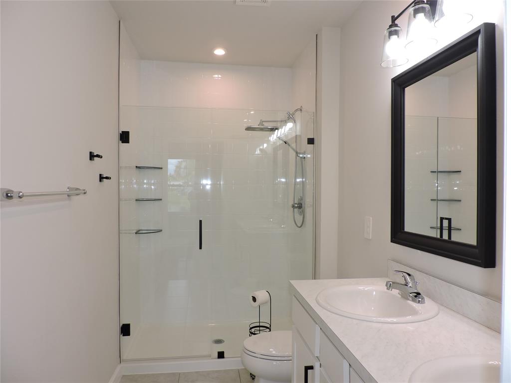 836 Persimmon Place Fort Pierce, FL 34981 - Photo 35 of 78 a bathroom with a bathtub shower sink and mirror