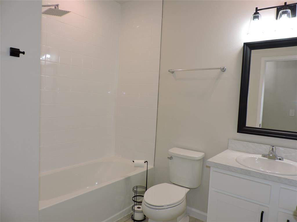 836 Persimmon Place Fort Pierce, FL 34981 - Photo 43 of 78 a bathroom with a granite countertop toilet a sink and a bathtub