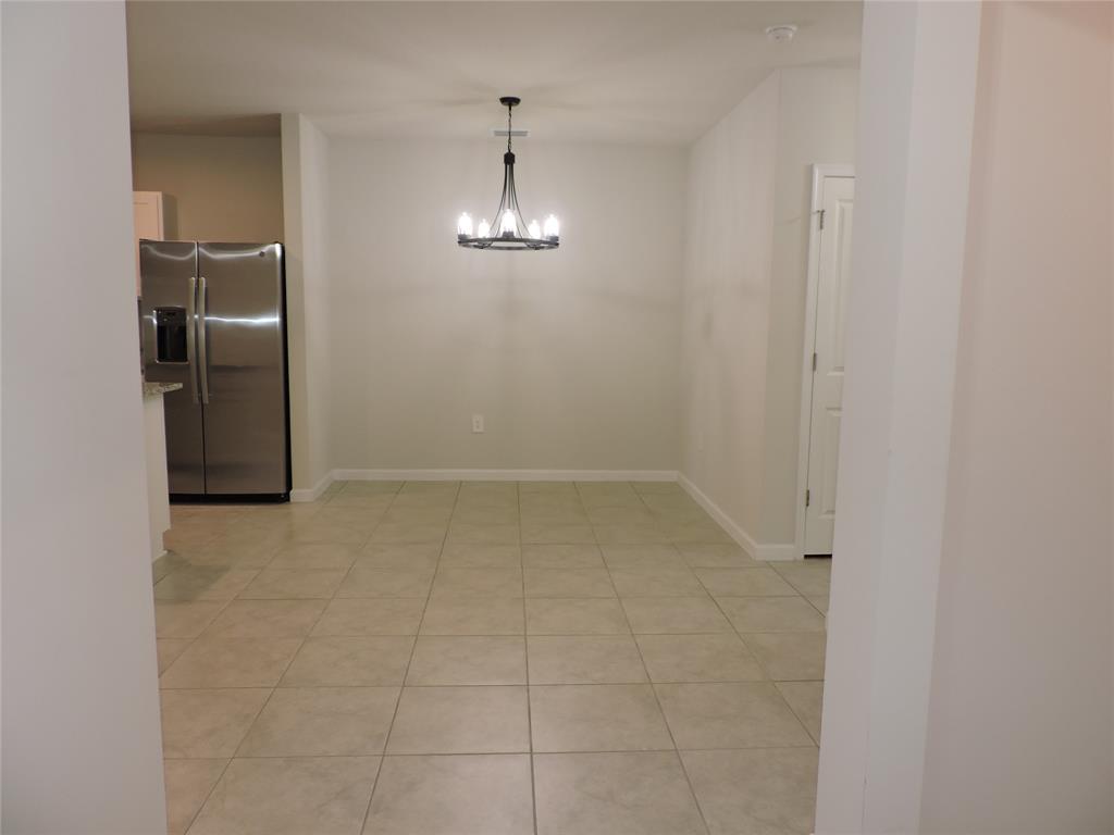 836 Persimmon Place Fort Pierce, FL 34981 - Photo 5 of 78 a view of empty room with wooden floor