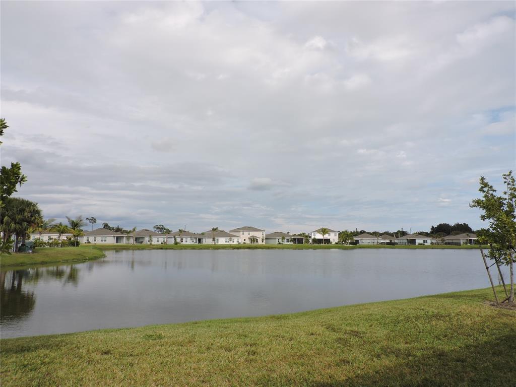 836 Persimmon Place Fort Pierce, FL 34981 - Photo 57 of 78 a view of a lake with houses in the back