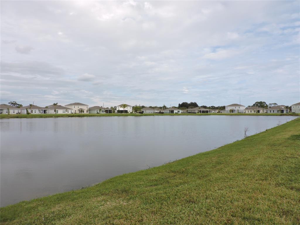 836 Persimmon Place Fort Pierce, FL 34981 - Photo 58 of 78 a view of a lake with houses in the back