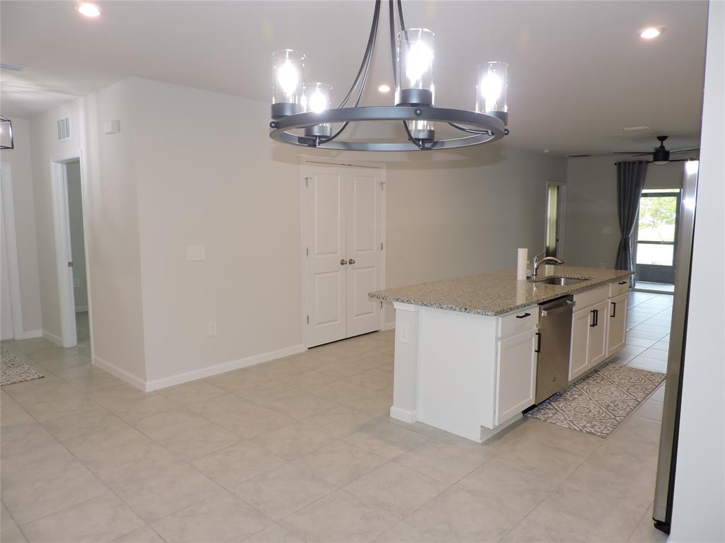 836 Persimmon Place Fort Pierce, FL 34981 - Photo 9 of 78 a kitchen with a stove and chandelier