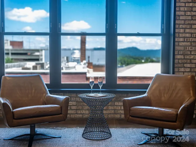 a bedroom with a bed and painting on the wall