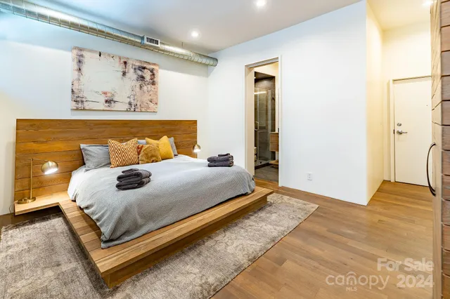 a bedroom with a bed and wall painting