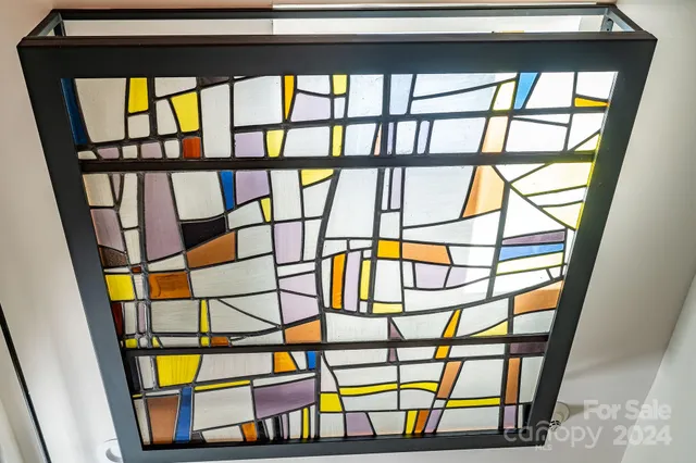 a bedroom with furniture and a large window